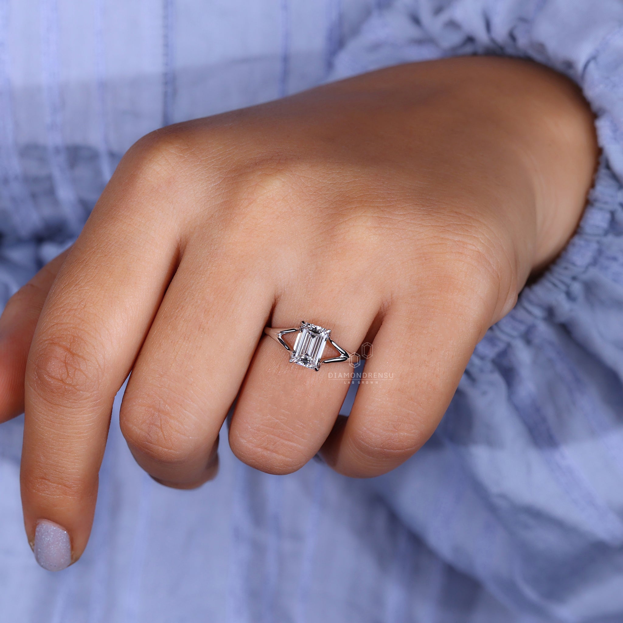 Model elegantly wearing a lab grown emerald cut diamond ring.