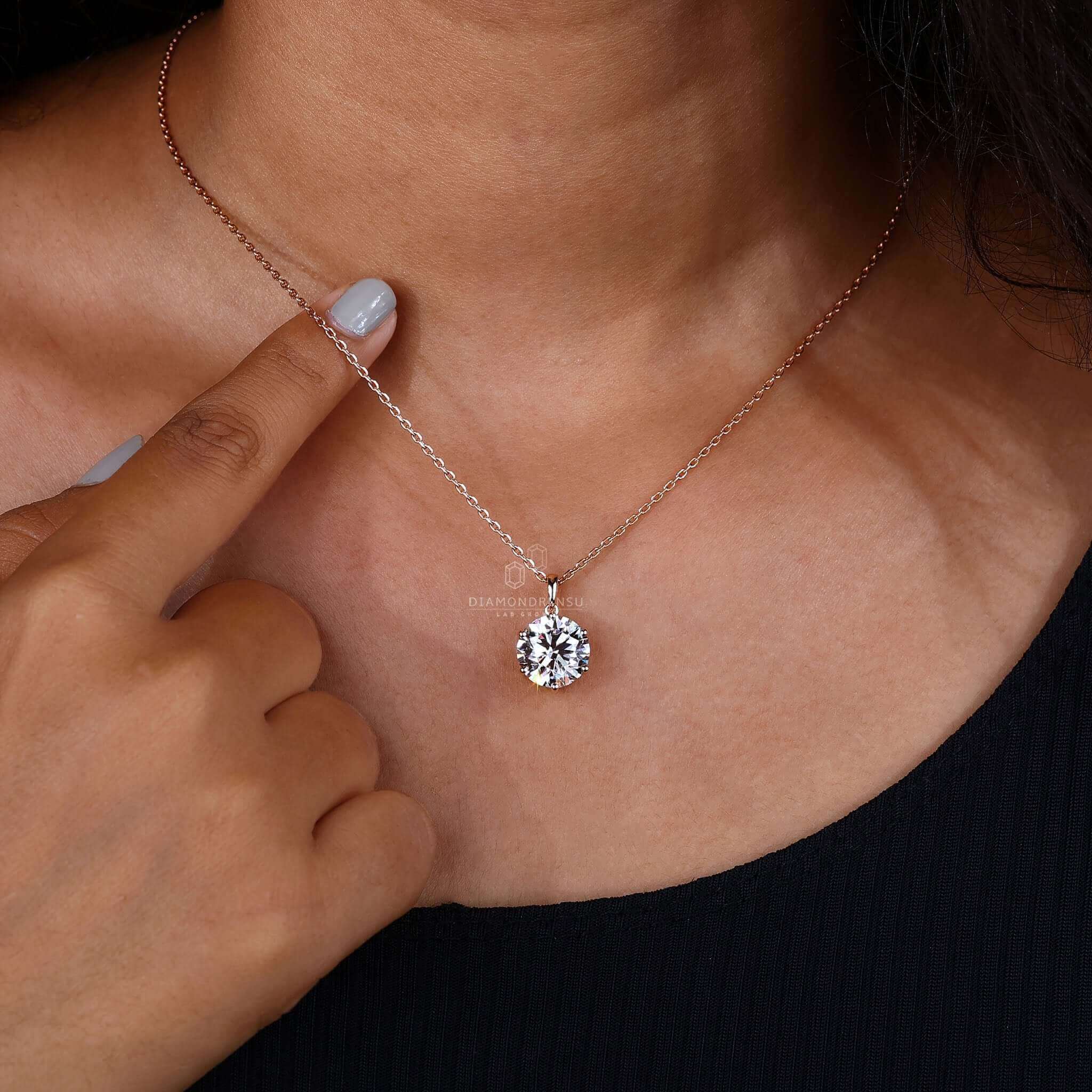 Solitaire diamond pendant on a model, perfect for special occasions.