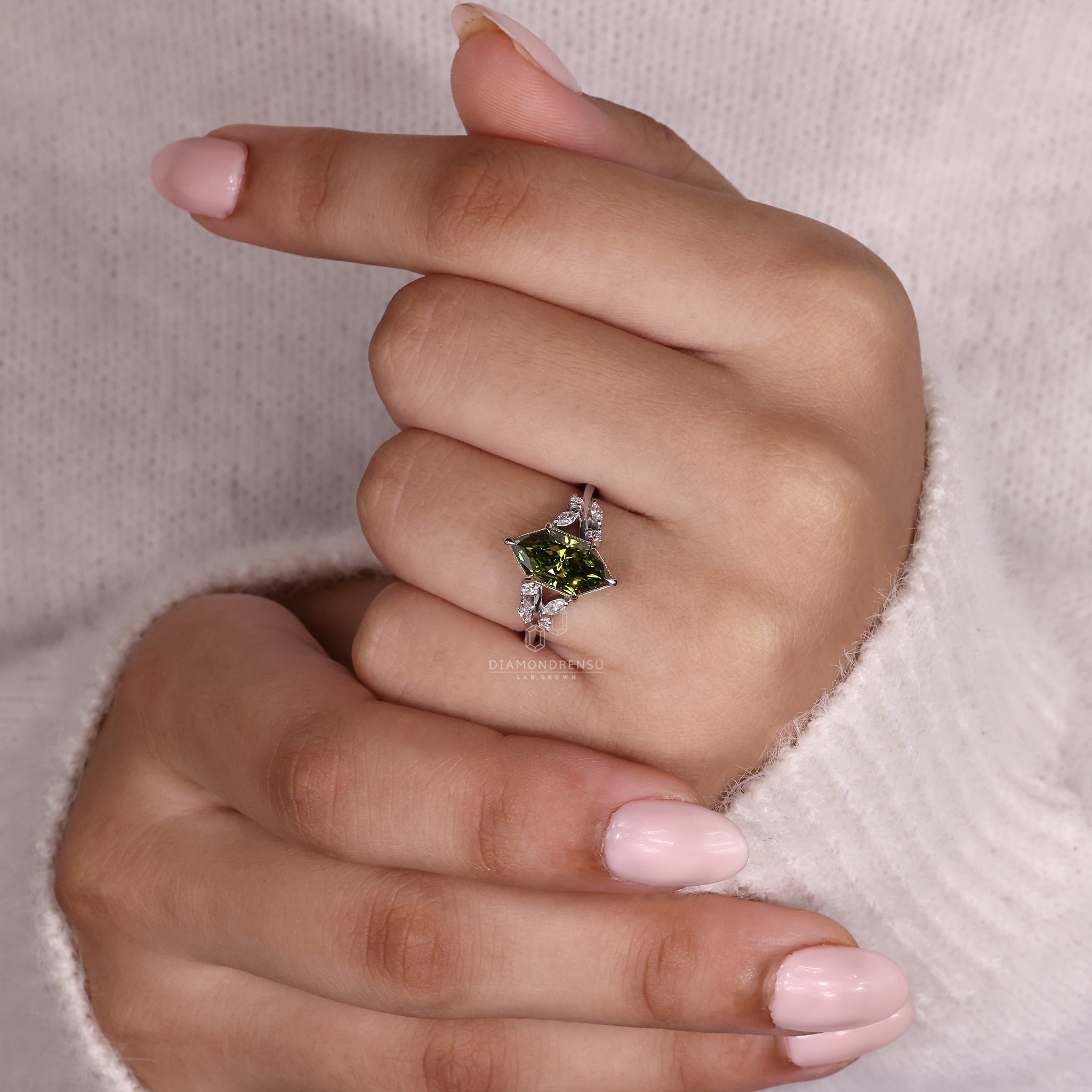 Nature inspired ring featuring a 2 carat lab grown Dutch marquise diamond, sidestones, and white gold band