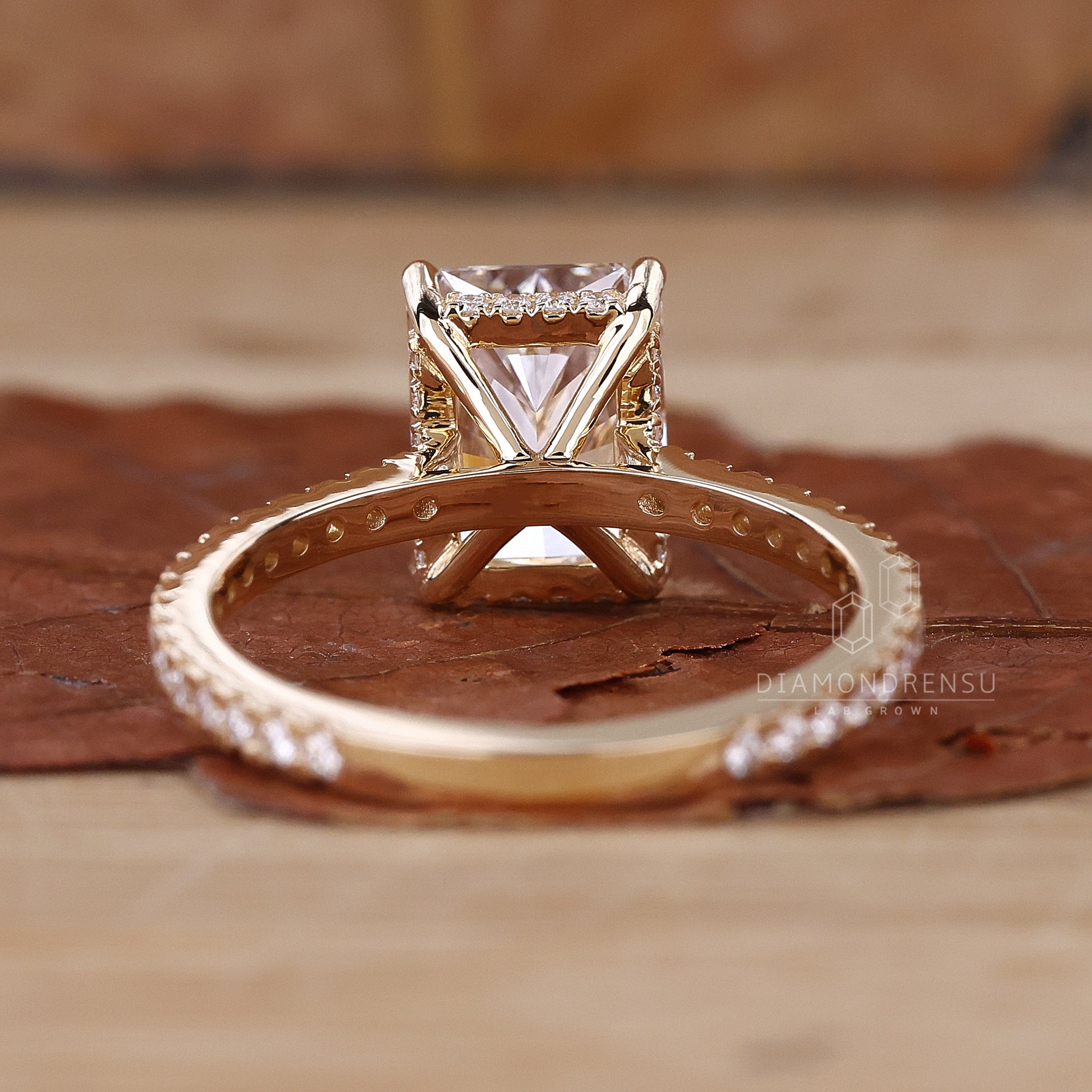 Diamondrensu radiant cut diamond ring with hidden halo engagement ring design and claw prongs, displayed elegantly