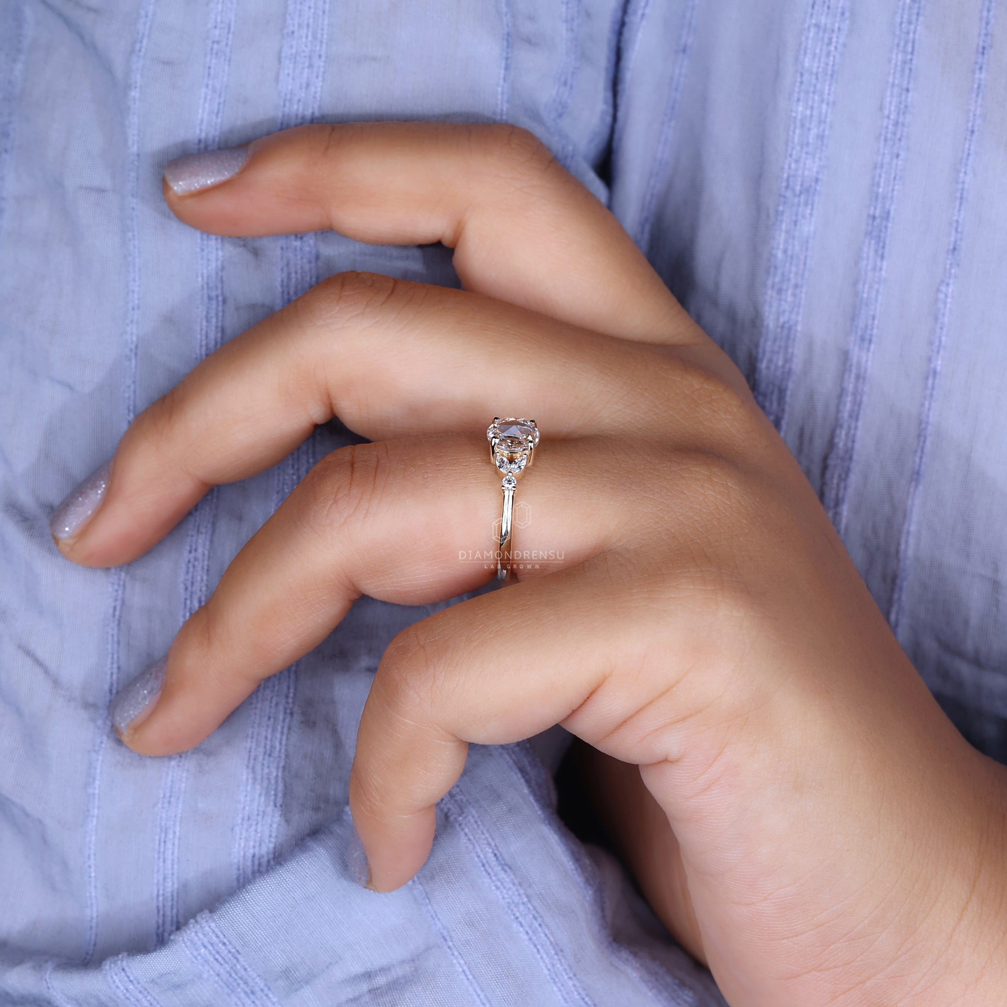 A model displaying a round rose cut diamond ring, highlighting its brilliance.