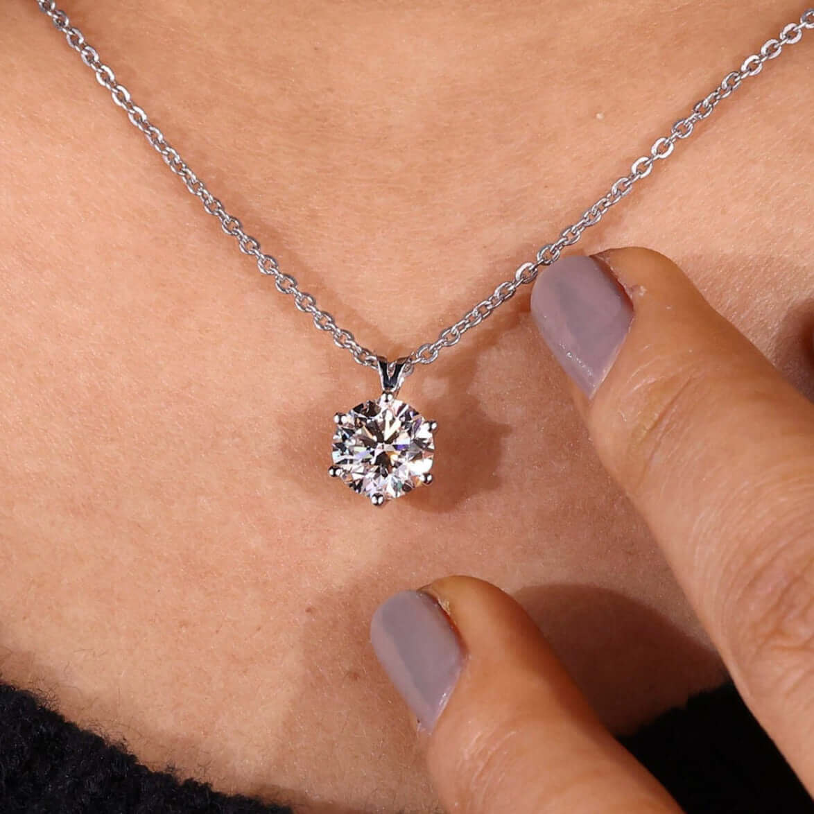 Model wearing diamond solitaire pendant