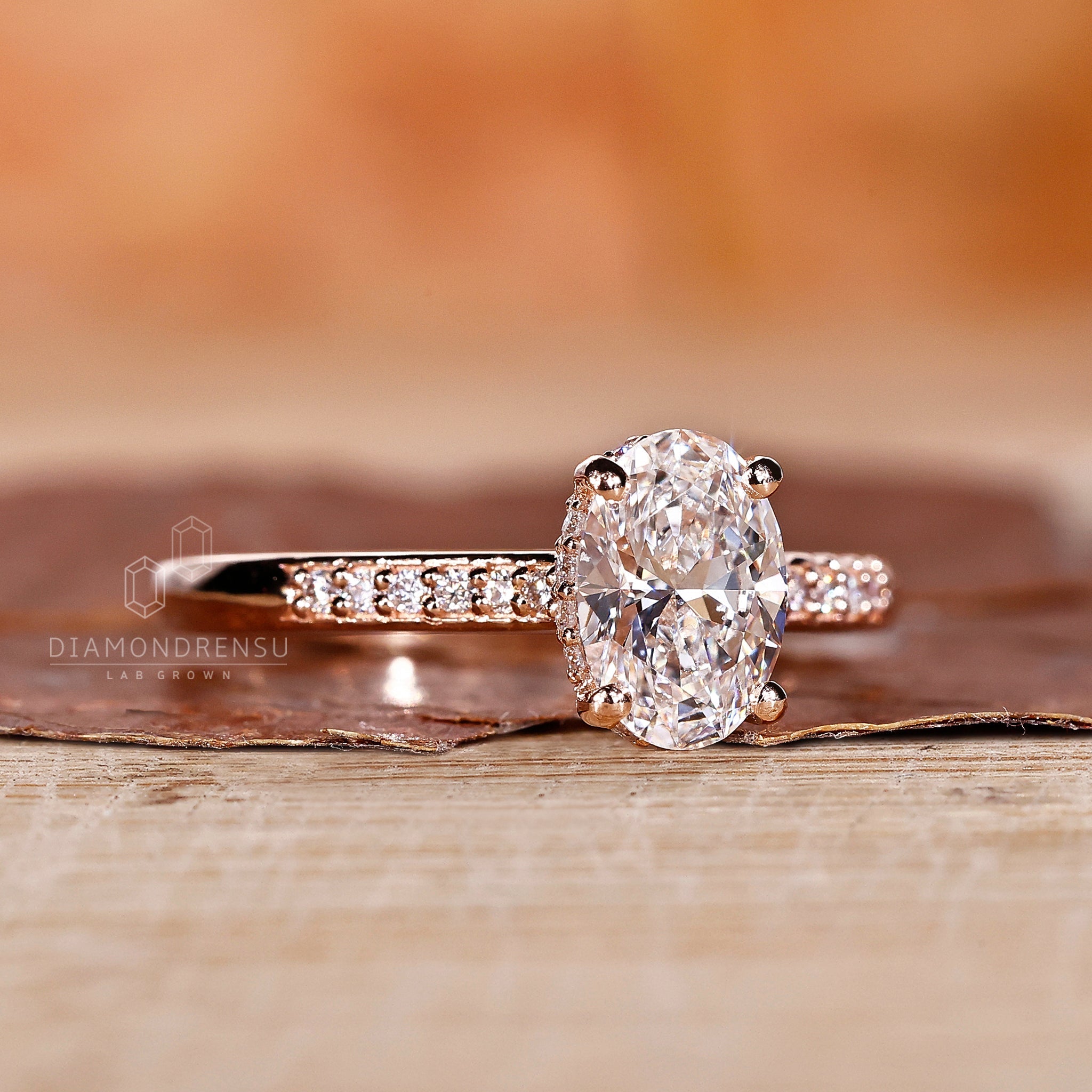 Top view of an oval lab grown diamond engagement ring with a hidden halo, capturing the shine and elegance of the piece.