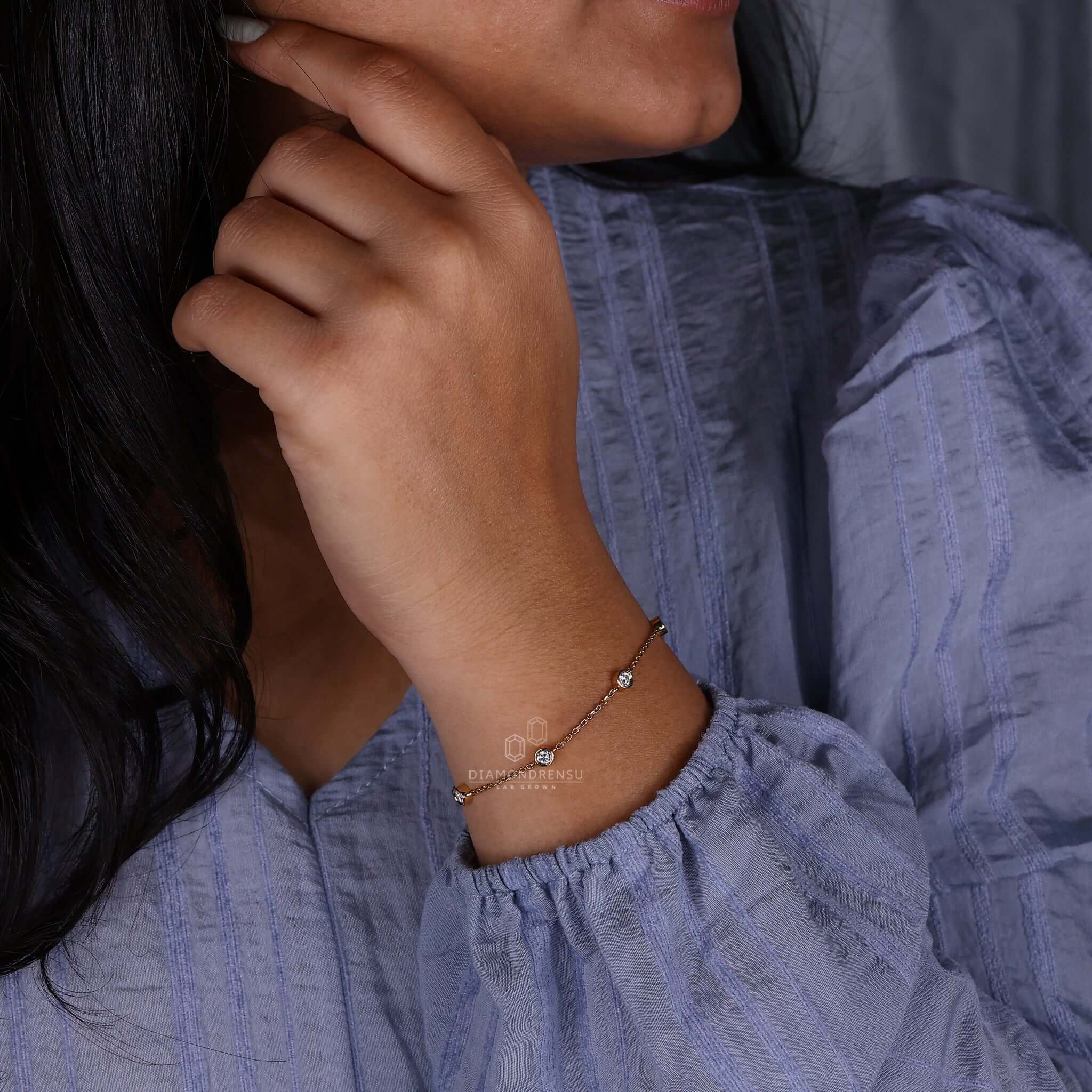 Close-up of a gold chain bracelet intertwined with a diamond chain link bracelet.