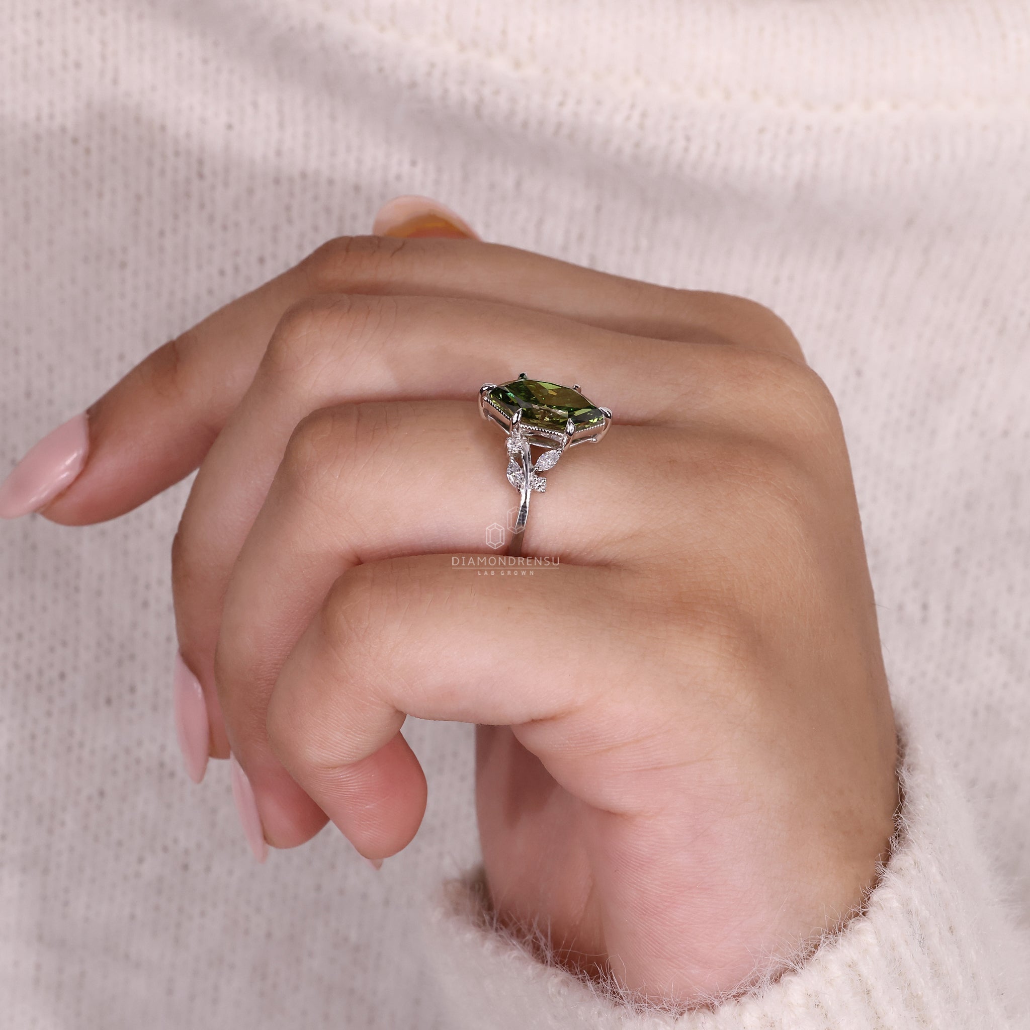 Model wearing a Diamondrensu nature inspired ring with a green Dutch marquise diamond and intricate sidestone design