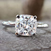 Cushion halo engagement ring featuring a stunning moissanite stone, perfect for a memorable proposal