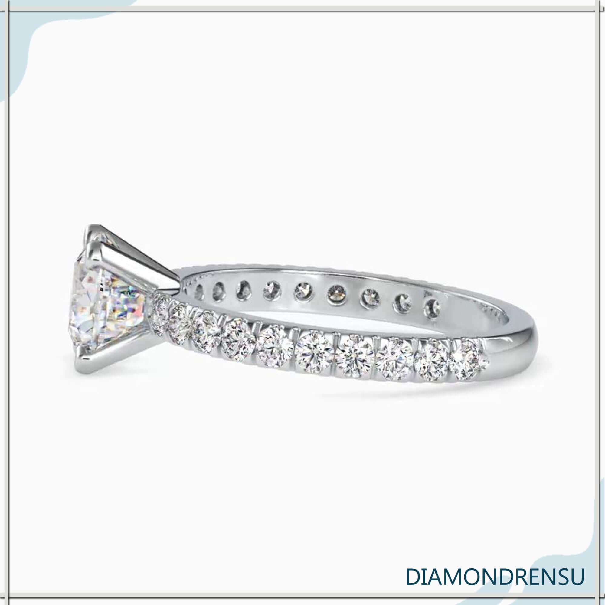 Diamond pave ring featuring a 2 carat cushion cut diamond, ideal for engagements.
