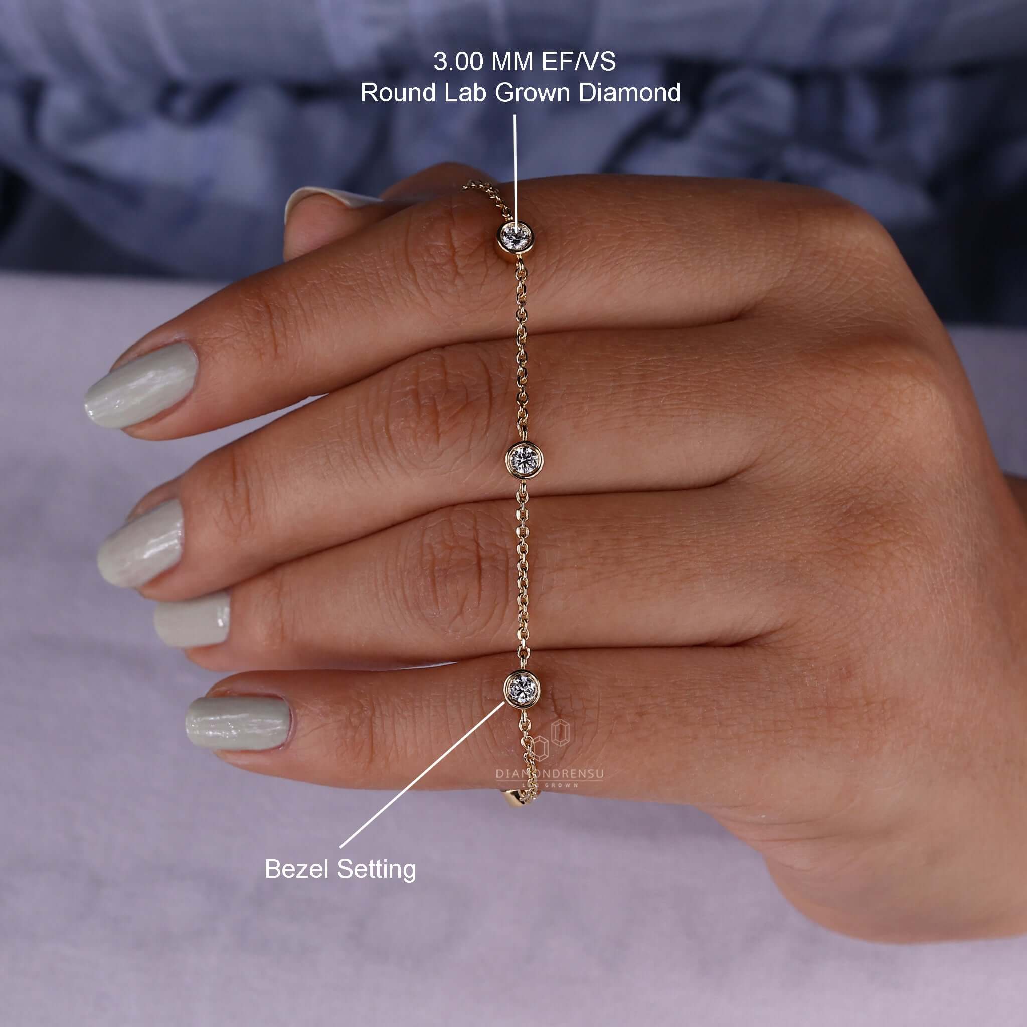 Model displaying a gold chain bracelet with a round diamond bracelet.