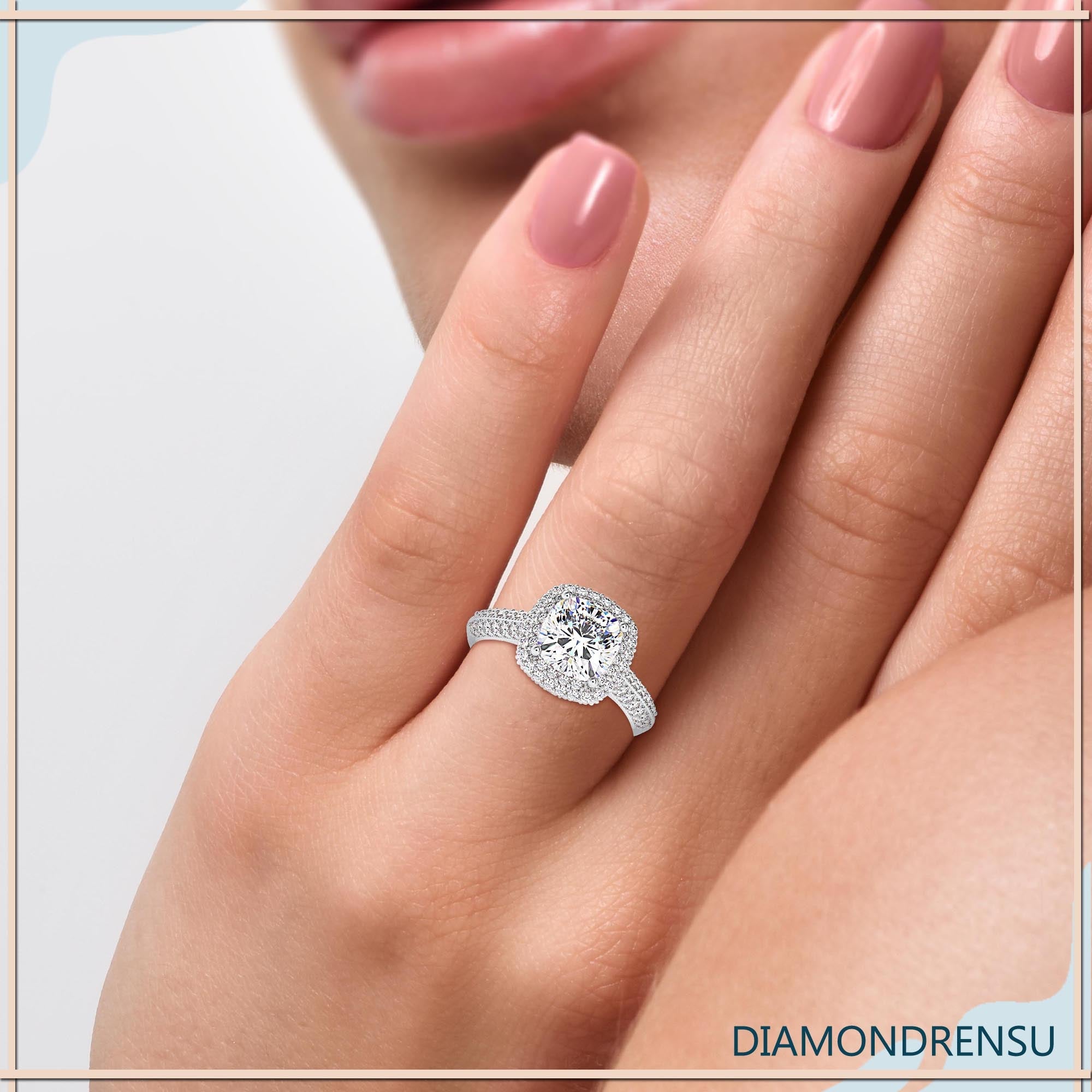 Classic cushion diamond cut engagement ring with a double row pave band.