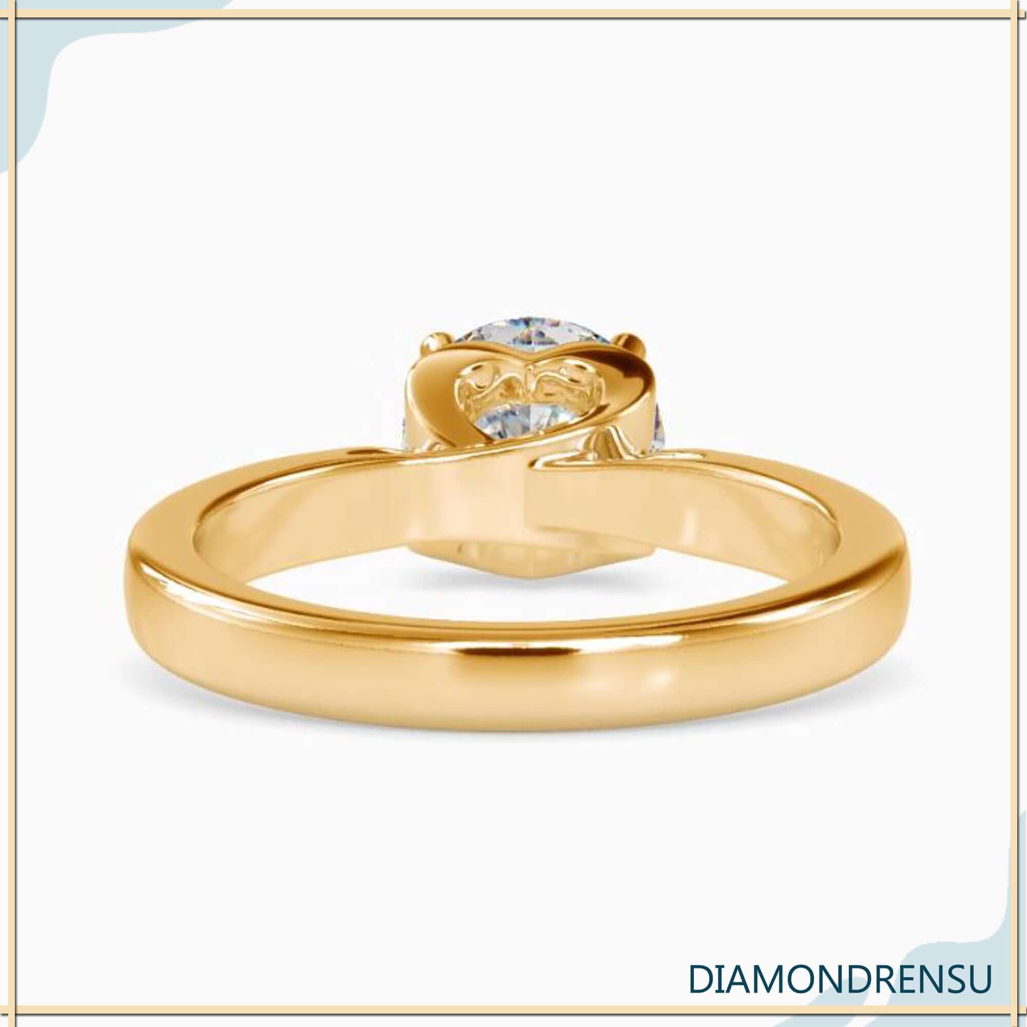 Heart basket yellow gold ring featuring a cathedral setting round diamond.