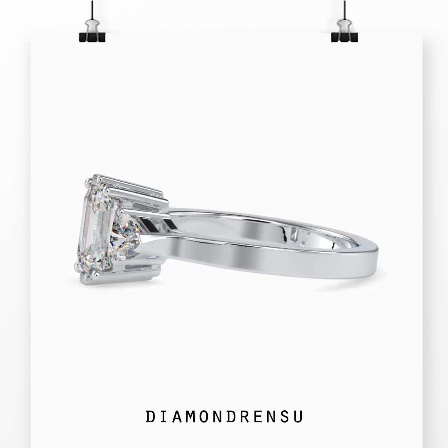 Trillion cut diamond ring with an emerald cut center for a timeless design.