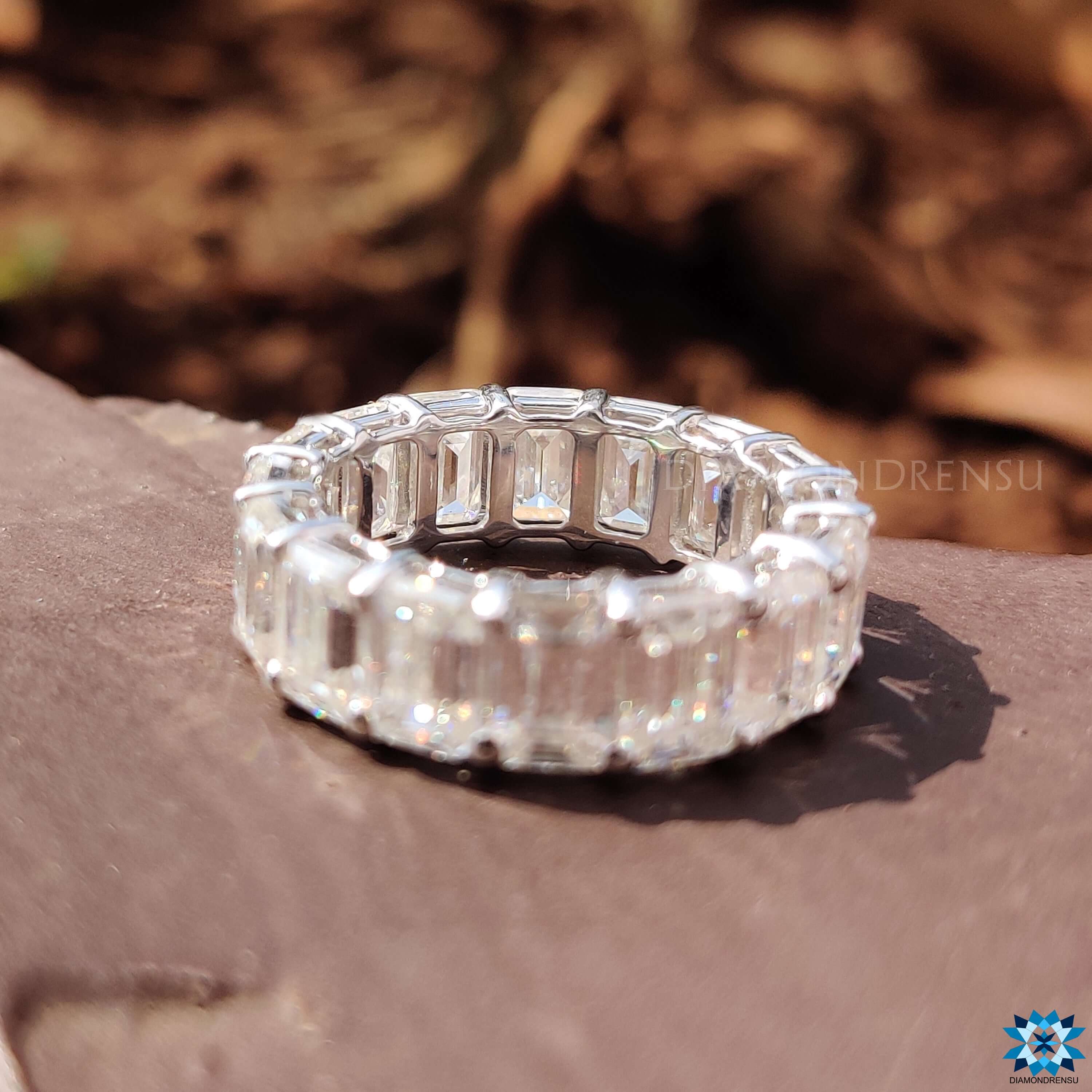 Handcrafted emerald and diamond eternity band with delicate detailing.