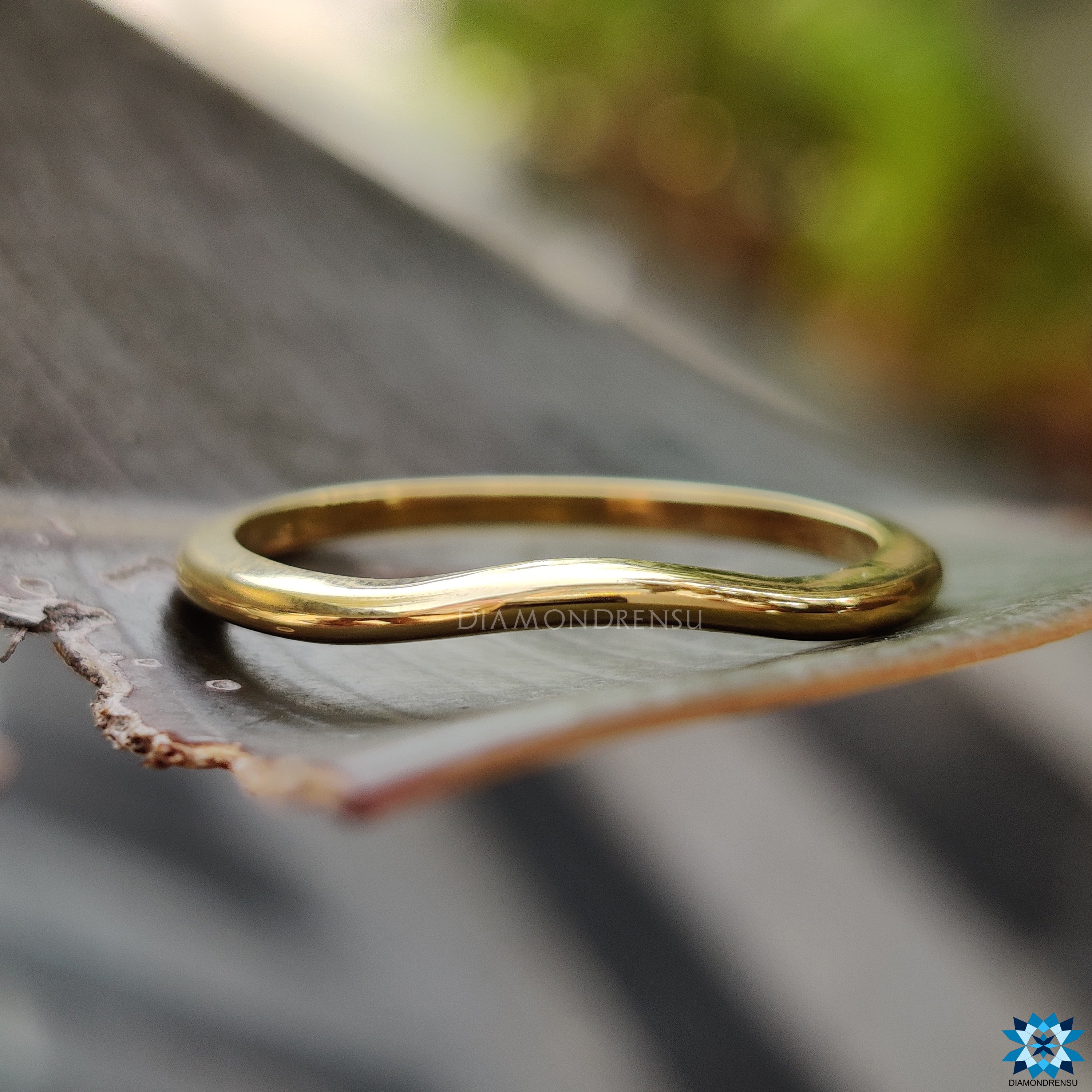 Yellow gold curved wedding band designed for effortless style.