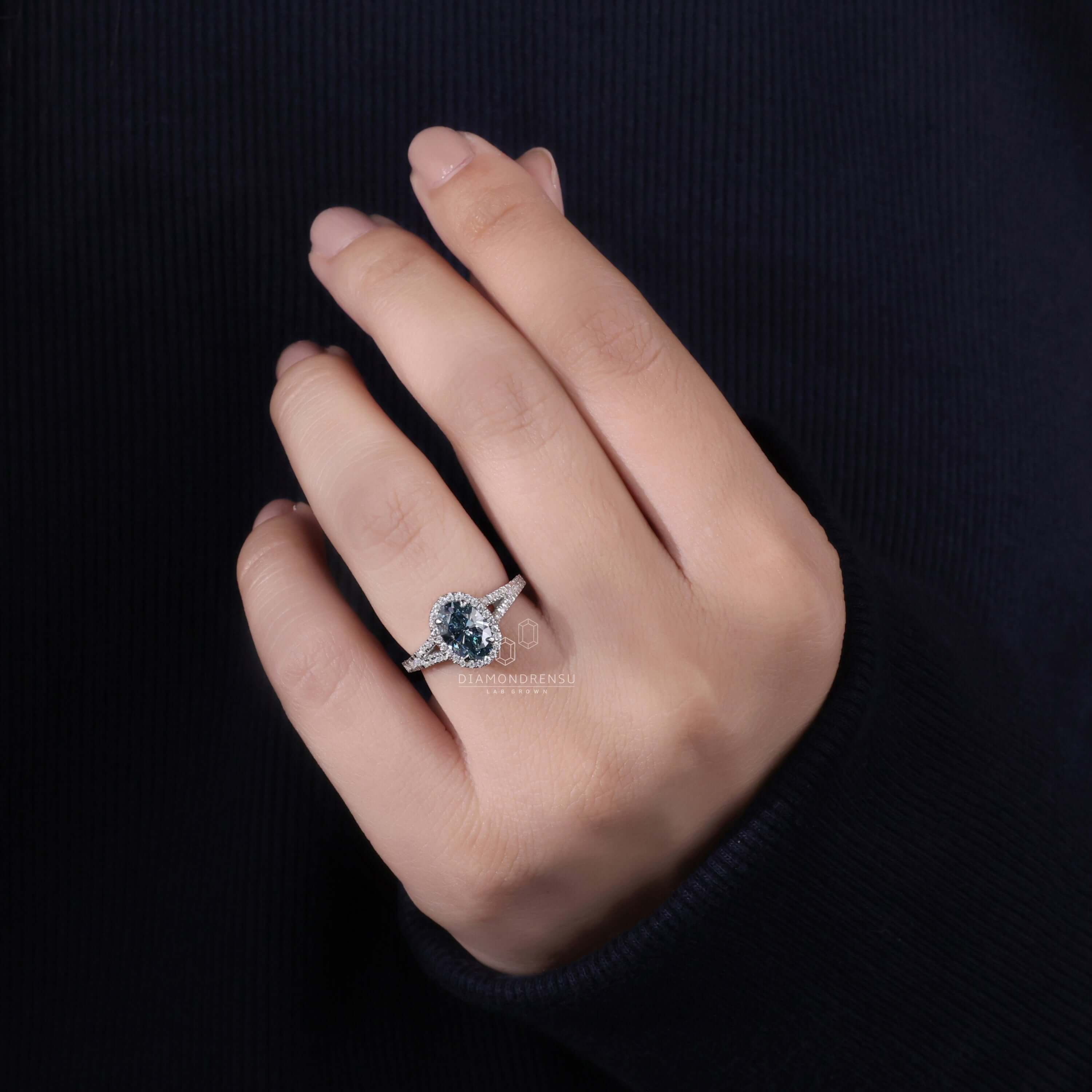 Oval Cut Blue Diamond Ring on Model Finger